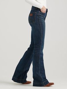 HAVE YOU MET BAILEY? Flattering from every angle, the Women’s Wrangler Retro® Bailey High Rise Trouser Jean is a best-kept secret for ladies who love volume. These denim trousers are crafted from a cotton blend with just a hint of stretch for all-day comfort. They come with a high-rise silhouette, a close fit through the thigh, and a 20.5” flared leg full of vintage vibes. Plus, the five-pocket styling, “W” pocket stitching, and logo patch bring an unmatched level of Western authenticity. Womens Western Wear, Pocket Stitching, Western Wear For Women, Wrangler Jeans, Denim Trousers, Vintage Vibes, Trouser Jeans, Women's Jeans, Western Wear