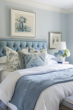 a bed with blue and white decor in a bedroom