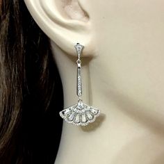 "Choose a pair of silver or rose gold cz linear bridal earrings in Gatsby Art Deco wedding style, featuring geometric fan shape dangles made of sparkly clear cubic zirconia with sterling silver posts in your choice of white, yellow and rose gold plating. Earrings are about 1 3/4\" (4.3cm) with posts. View matching pieces or similar designs at https://etsy.me/2UncS3p See all geometric designs at https://etsy.me/2eKf6s8 View all earrings at https://etsy.me/1f8VFT4" Wedding Diamond Dangle Earrings, Wedding Diamond White Hand Set Earrings, Wedding White Gold Crystal Earrings With Diamond Accents, Dangle Bridal Earrings With Diamond Accents For Wedding, White Gold Crystal Earrings With Diamond Accents For Wedding, Classic Diamond Chandelier Earrings For Wedding, Hand Set Cubic Zirconia Dangle Bridal Earrings, Classic Wedding Chandelier Earrings With Diamond Accents, Elegant Hand Set Diamond Earrings For Wedding