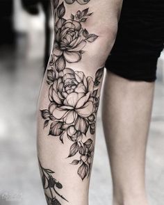 a woman's leg with flowers on it