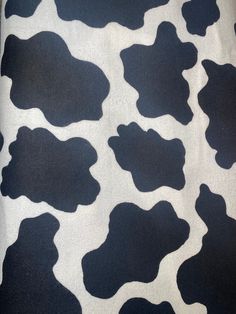 black and white cow print fabric with spots on it's back side, showing the pattern