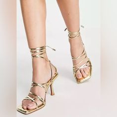 New Beautiful Hiccup Strappy Tie Leg Mid Heeled Sandals In Gold Gold Lace-up Sandals With Heel Strap For Summer, Gold Strappy Lace-up Sandals, Gold Strappy Sandals With Heel Strap, Gold Strappy Heels For Summer, Glamorous Strappy Sandals For Spring, Trendy Gold Sandals With Wrapped Heel, Gold Strappy Heels For Spring, Chic Gold Lace-up Sandals For Party, Chic Gold Lace-up Sandals For Evening