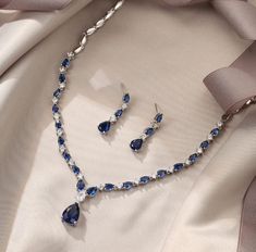 Bridal Blue Sapphire September Birthstone Water Drop Necklace & Dangle Earrings Set Elevate your wedding day look with the Bridal Blus Sapphire Water Drop Necklace & Dangle Earrings Set, a stunning jewelry ensemble designed to add a touch of elegance and sophistication to your special occasion. This exquisite set is perfect for brides who want to make a statement with their accessories, featuring the mesmerizing allure of sapphire--the birthstone of September. Product Details: Design: The set in Luxury Lab-created Sapphire Wedding Jewelry, Sapphire Wedding Jewelry, Water Drop Necklace, Dnd Oc, Blue Sapphire Necklace, Vox Machina, Drop Pendant Necklace, Sapphire Wedding, Wedding Jewellery