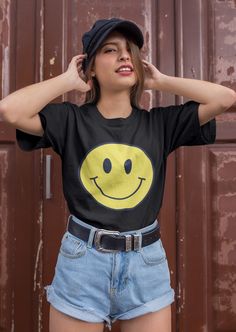 Smiley face shirt. So soft, so lightweight, so comfortable, so chic! This is a unisex fit. Size up for an oversized look or stay true to size for a classic fit. * 100% combed and ring-spun cotton  This product is made to order just for you! Please allow 2-7 business days for processing plus shipping time. Cheap Fun Smiley Face T-shirt, Cute Funny Print T-shirt For Streetwear, Cute T-shirt With Funny Print For Streetwear, Cute Everyday T-shirt With Screen Print, Fun Short Sleeve T-shirt For Streetwear, Fun Cotton T-shirt With Smiley Face, Cute Black Short Sleeve T-shirt, Fun Everyday Short Sleeve T-shirt, Funny Print T-shirt For Everyday