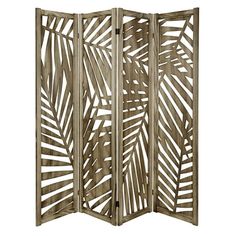 a wooden room divider with palm leaves on it