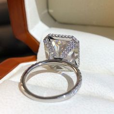 a diamond ring sitting on top of a white cloth