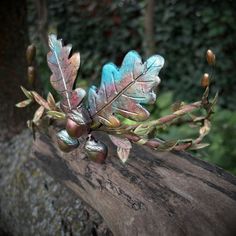 An enchanting handmade Woodland Crown, a statement headpiece designed to bring the beauty of the forest to life. This unique headpiece is the perfect addition to your costume for Renaissance faires, festivals, or simply to embrace the spirit of the woodland.The crown features a collection of handmade polymer clay oak leaves, hand-painted in the warm and earthy hues of Autumn. Among them, you'll find three charming acorns, symbolizing the season's bounty. Brown branches, flexible and adaptable, i Whimsical Crown Shaped Handmade Headband, Whimsical Handmade Crown Headband, Handmade Fantasy Costume Headpieces, Handmade Fantasy Headpieces, Unique Handmade Crown Headpiece, Handmade Fantasy Headpieces For Festivals, Whimsical Handmade Headband, Handmade Festival Fantasy Headpieces, Handmade Adjustable Costume Headpiece