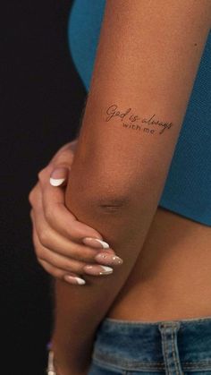 a woman's arm with a tattoo saying god is always with me