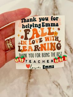 someone is holding up a card that says thank you for helping emma fall in love with learning