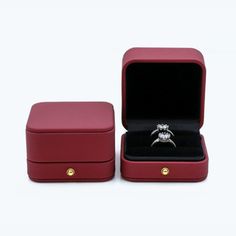 an open red box with a ring in it