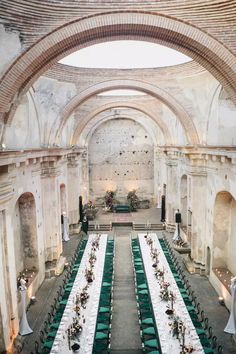 an empty banquet hall with long tables and white tablecloths