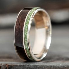 a wedding ring with wood and green moss inlay