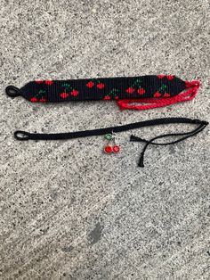 a pair of red and black knitted items laying on the ground