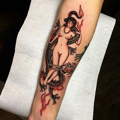 a woman with a snake tattoo on her arm