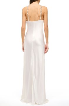 This simply elegant satin gown is designed with beaded straps and sleek cutaway shoulders. 64" length (size 8) Back zip closure V-neck Sleeveless, with cutaway shoulders 100% polyester Dry clean Imported Fitted Floor-length Satin Slip Dress, Floor-length Fitted Satin Slip Dress, Silk Evening Dress With Spaghetti Straps For Wedding, Sleeveless Gown With Satin Finish And Fitted Bodice, Satin Finish Sleeveless Gown With Fitted Bodice, Silk Sleeveless Evening Dress With Satin Finish, Glamorous Sleeveless Gown With Satin Finish, Satin Evening Dress With Sweetheart Neckline And Back Opening, Full-length Satin Slip Dress For Evening