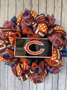 the chicago bears deco mesh wreath is decorated with footballs and polka dot bow ties