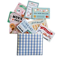 several different types of movie tickets in a small pocket on a white background with clippings