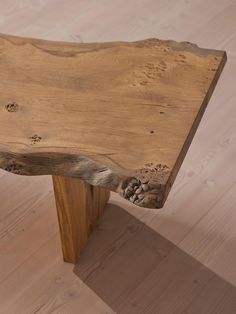 a wooden bench sitting on top of a hard wood floor