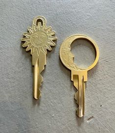 two gold keys with the sun and moon on them