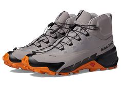 Salomon Cross Hike 2 Mid GORE-TEX(r) - Men's Shoes : Gull Marmalade Black : Let your feet feel comfortable all-day long wearing the Salomon Cross Hike 2 Mid GORE-TEX shoes. Textile and synthetic upper. Textile lining. Removable textile insole. Round toe. Bungee lace closure. Ankle and tongue pull tab. Synthetic outsole. Imported. Measurements: Weight: 13 oz Product measurements were taken using size 9, width D - Medium. Please note that measurements may vary by size. Gray Waterproof Lace-up Boots For Sports, Gore-tex Dynamic Lace-up Sneakers, Dynamic Gore-tex Lace-up Sneakers, Waterproof Lace-up Running Boots With Vibram Sole, Lace-up High-top Sneakers For Hiking, Ergonomic Lace-up Walking Shoes With Vibram Sole, Dynamic High-top Sneakers With Round Toe For Outdoor, High-top Hiking Boots With Rubber Sole For Sports, High-top Running Shoes With Rubber Sole For Trail Running