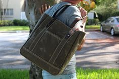 tote / carry all bag  All heavy duty waxed canvas and genuine leather accents.  This premium grade waxed canvas is water resistant. The material was carefully selected from the best textile supplier in the USA.  The handles are made of beautiful thick brown leather. S P E C S - dark brown leather handles and accents - American Heavyweight waxed 19 Oz. - shown in FIELD TAN WAXED CANVAS ( other options at checkout ) - 2 exterior deep pockets - 1 interior zippered compartment - 6 interior drop pockets - This bag is FULLY lined - padded bottom - industrial hardware ( COPPER RIVETS ) - hardware is very good quality - Nylon Mil-Spec thread - Made in USA D I M E N S I O N S 16" total top wide opening 14" high 5" deep 13" wide at the bottom 10" handle drop HEAVY WAX CANVAS CARE: - do not wash - do Luxury Large Capacity Waxed Canvas Shoulder Bag, Rugged Canvas Bags With Large Capacity, Large Capacity Waxed Canvas Tote Bag, Black Waxed Canvas Tote Shoulder Bag, High-end Rectangular Canvas Bag With Waxed Finish, Wax Canvas, Mil Spec, Industrial Hardware, Leather Accents