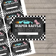 four diaper raffle coupons on top of a wooden table with checkered paper