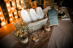 the table is set with white dishes and candles