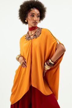 Topaz high-low tunic style kaftan with sequins, beads embroidered neckline.
Components: 1
Pattern: Plain
Neckline: V Neck
Sleeve Type: Split Sleeves
Fabric: Natural Crepe
Color: Yellow
Other Details: 
Tunic Length - 28 Inches
Note: The pant and accessories worn by the model are not for sale
Occasion: Resort - Aza Fashions Silk Cape Kaftan, Festive Embellished Tunic Kaftan, Embellished Kaftan With Kimono Sleeves For Eid, Eid Embellished Kaftan With Kimono Sleeves, Festive Embellished Kaftan With Kimono Sleeves, Bohemian Kaftan With Cape Sleeves For Festive Season, Bollywood Style Embellished Festive Thobe, Festive Bohemian Kaftan With Cape Sleeves, Festive Bollywood Style Embellished Thobe