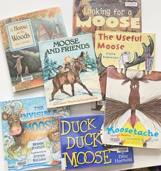 there are many children's books on the table together, including moose, moose, and other animals