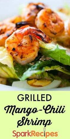 grilled mango - chili shrimp with lettuce and lemon wedges on a plate