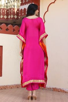 Magenta satin silk kaftan with placement floral gota work. Paired with a pant. Comes along with an inner - Aza Fashions Bollywood Style Floor-length Sets With Embroidered Border, Festive Silk Kaftan With Gota Work, Festive Silk Palazzo Set With Embroidered Border, Silk Kaftan With Gota Work In Traditional Drape, Floor-length Embroidered Sets For Navratri, Satin Sharara For Diwali, Navratri Floor-length Embroidered Sets, Floor-length Embroidered Border Sets For Navratri, Navratri Embroidered Floor-length Sets