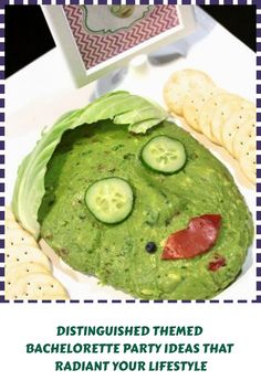 a sandwich with cucumbers on it and crackers in the shape of faces