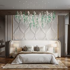 a large bed sitting under a chandelier next to a white headboard in a bedroom