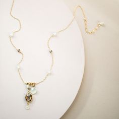 "Jeweled necklace on a delicate gold chain. Necklace features a beautiful bezel set smoky quartz gemstone surrounded by aqua chalcedony accent stones. - Total necklace length is 18-20\" - Chain length 16-18\" long with the 2\" extender - Pendant drop is 2\" - 14k gold plated fine Italian sterling silver (stamped for authenticity) - Spring ring clasp These necklaces are great gifts and arrive in a gift box. Our jewelry is always made in the USA in our New York City studio. The unique natural shap Delicate Gold Necklaces With Gemstone Accents, Delicate Gold Necklace With Gemstone Accents, Gold Faceted Chalcedony Jewelry, Jeweled Necklace, Multi Gemstone Necklace, Delicate Gold Chain, Nyc Studio, Bezel Necklace, Jewel Necklace