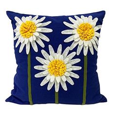 a blue pillow with white and yellow flowers on it