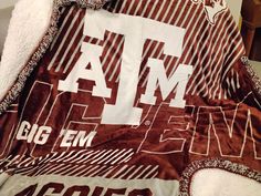 the comforter is made up with maroon and white letters on it's side