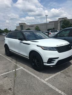 a white range rover parked in a parking lot