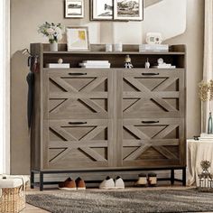 a wooden dresser in a living room with pictures on the wall above it and an area rug