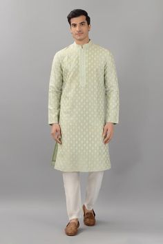 Pistachio green silk kurta with mandarin collar, all over floral butti pattern and thread embroidery. Paired with white straight fit pants.
Components: 2
Pattern: Embroidered
Type Of Work: Thread Work
Neckline: Mandarin Collar
Sleeve Type: Full Sleeves
Fabric: Silk
Color: Green
Other Details: 
Embroidered collar and placket
Side slits on kurta
Kurta Closure: Front button placket
Occasion: Mehendi and Puja,Sangeet - Aza Fashions Green Chanderi Sherwani With Cutdana Details, Green Chanderi Sherwani With Cutdana, Festive Green Chanderi Bandhgala, Green Chanderi Bandhgala With Zari Work, Green Chanderi Bandhgala With Cutdana, Transitional Green Chanderi Bandhgala, Green Chanderi Sherwani For Eid, Green Chanderi Bandhgala For Transitional Season, Pista Green Kurta With Resham Embroidery For Spring