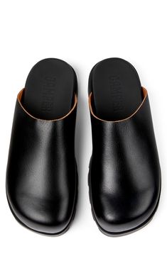 A surprisingly lightweight sole brings everyday comfort to this minimalist mule crafted from smooth leather. Cushioned footbed Leather upper and lining/synthetic sole Imported Modern Slip-on Slides With Leather Sole, Modern Leather Slip-ons With Cushioned Footbed, Comfortable Flat Heel Mules With Leather Footbed, Comfortable Mules With Leather Footbed And Flat Heel, Leather Mules With Removable Insole, Black Leather Slip-on Mules, Leather Mules With Branded Insole And Round Toe, Leather Clogs With Plain Toe, Leather Closed Toe Mules With Rubber Sole