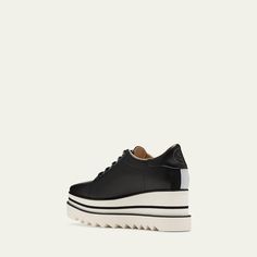 Stella McCartney "Sneakelyse" sneaker loafers in two-tone faux leather (polyurethane) 3.15 in / 80 mm colorblock demi-wedge heel; 2.75 in / 70 mm platform Round toe Lace-up vamp Web strap and logo accent at backstay Shark tooth rubber sole Made in Italy Vegan Logo, Platform Loafers, Shark Tooth, Shark Teeth, Wedge Heels, Stella Mccartney, Rubber Sole, Color Blocking, Tops Designs