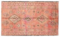 an old rug with many different colors and patterns on the ground, including pinks