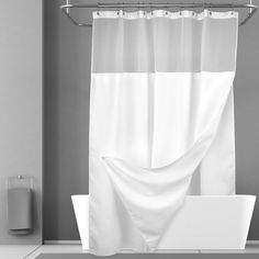 a white bath tub sitting next to a shower curtain