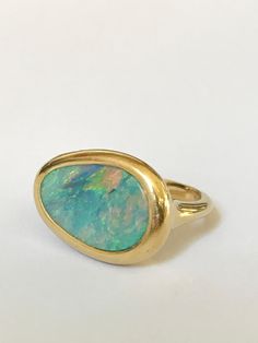 Modern Yellow Gold Oval Opal Ring, Modern Gold Oval Opal Ring, Modern Oval Yellow Gold Opal Ring, Modern Oval Opal Ring In Yellow Gold, Modern Yellow Gold Opal Ring Gift, Modern Oval Opal Ring With Bezel Setting, Yellow Gold Opal Ring With Bezel Setting, Modern Opal Ring With Bezel Setting, Classic Yellow Gold Opal Ring With Bezel Setting