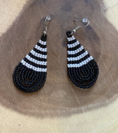 These handmade beaded earrings are truly unique. Each one is hand made with a rotating pattern. These earrings are available in a multitude of colors -making them perfect for any outfit! Whether it's dressing up a jean jacket or adding a unique texture to a LBD, there's no way you can go wrong with these earrings! We have given each design a name in honor of our favorite people! Handmade Casual Beaded Earrings, Casual Handmade Beaded Earrings, Trendy Handmade Black Beaded Earrings, Trendy Handmade Teardrop Beaded Earrings, Casual Handmade Beaded Dangle Earrings, Unique Black Beaded Earrings, Handmade Black Casual Earrings, Handmade Casual Black Earrings, Artisan Black Beaded Earrings With Ear Wire