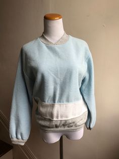 Vintage items make great unique and unexpected gifts. Vintage 80s Sweatshirt | Richard Simmons Workout Top | Retro Baby Blue Sweatshirt | Throwback Willy-Dee Colorblock 80s Gym Top | Campus Top CONDITION: Vintage Excellent MEASUREMENTS: 21" sleeve 19" shoulder to shoulder 22.5" long 39" chest 28" across bottom  LABEL SIZE: M BRAND: Willy-Dee // Made in the USA  FEATURES: Totally retro sweat top with colorblock concept baby blue, gray and white; high v-neck.  Shop VintageBobbieMaude for MORE: https://www.etsy.com/shop/VintageBobbieMaude Vintage Oversized Tops With Ribbed Cuffs, Oversized Vintage Tops With Ribbed Cuffs, Retro Crew Neck Sweatshirt For Loungewear, Retro Crew Neck Top For Loungewear, Vintage Crew Neck Tops For Loungewear, Vintage Cotton Sweater For Loungewear, Vintage Crew Neck Sweatshirt For Loungewear, Retro Winter Loungewear Tops, Retro Blue Tops For Loungewear