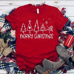 S 4 M 6 L 8/10 Xl 12 Merry Christmas Multi Tree Screen Print Tee. Pictured On Red. Soft Tee. Material Is Cotton And Polyester Red Short Sleeve Holiday Top, Red Short Sleeve Top For Holidays, Red Short Sleeve Tops For Winter, Red Festive Holiday Top, Red Holiday Tops For Festive Occasion, New Year Holiday Crew Neck T-shirt, Casual Red Christmas Tops, Red Graphic Print T-shirt For New Year, Crew Neck T-shirt For New Year's Holiday