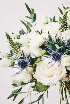 a bouquet of white flowers with green leaves