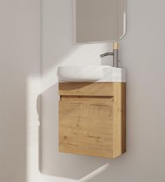 a bathroom sink with a wooden cabinet underneath it and a mirror on the wall above it