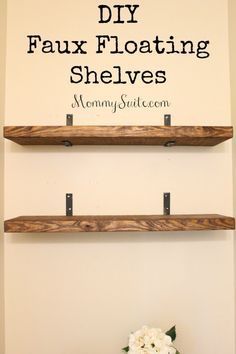 two wooden shelves with flowers on top and the words diy faux floating shelves above them